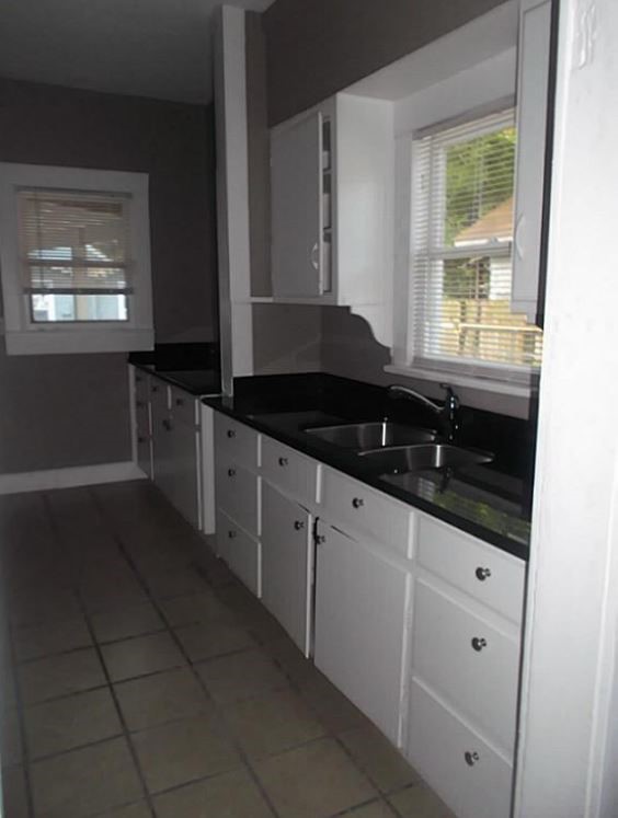720 East 12th Street Houston, TX 77008 - Photo 5 of 10 a kitchen with granite countertop a stove a sink and a window