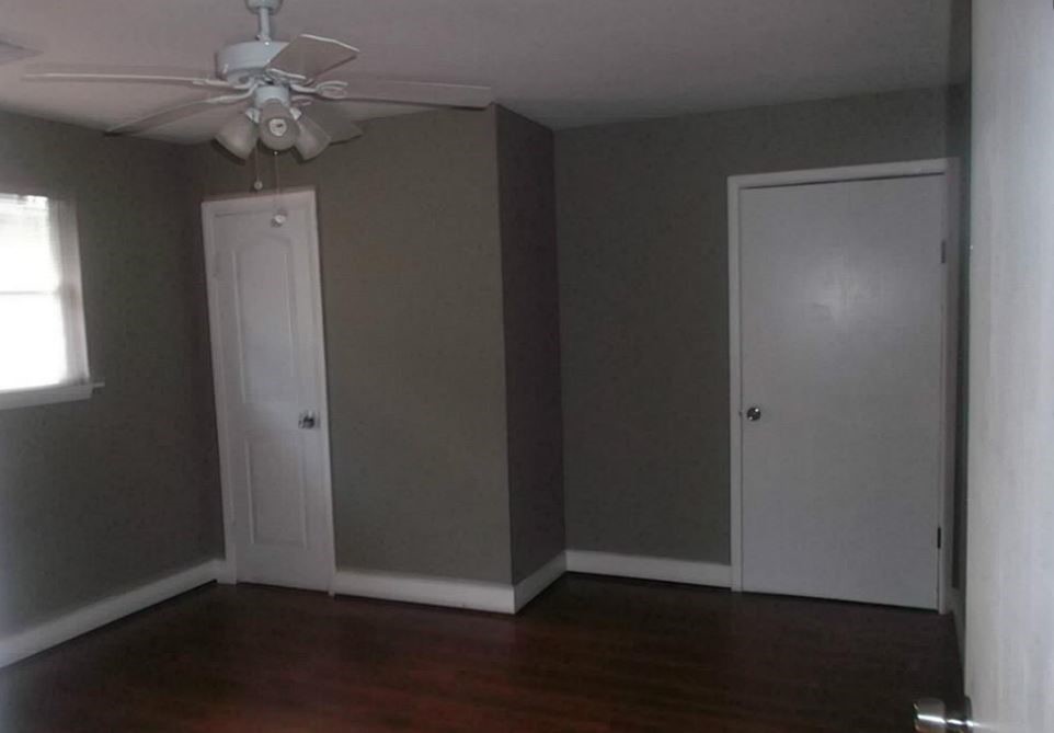 720 East 12th Street Houston, TX 77008 - Photo 7 of 10 an empty room with wooden floor and ceiling fan