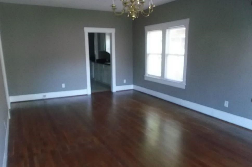 720 East 12th Street Houston, TX 77008 - Photo 9 of 10 an empty room with wooden floor and windows