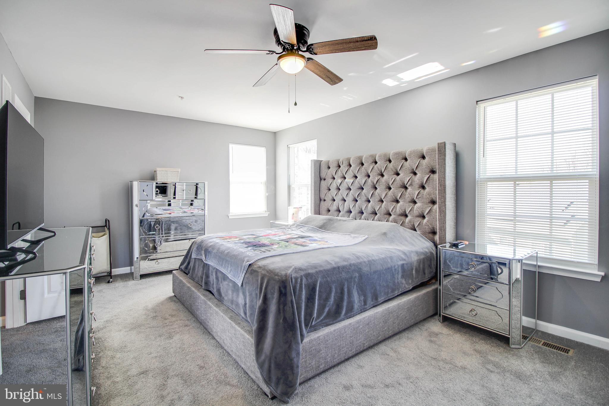 1634 Cape May Road Essex, MD 21221 - Photo 18 of 27 a spacious bedroom with a bed and a flat tv screen on the dresser