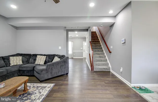 a living room with furniture and wooden floor