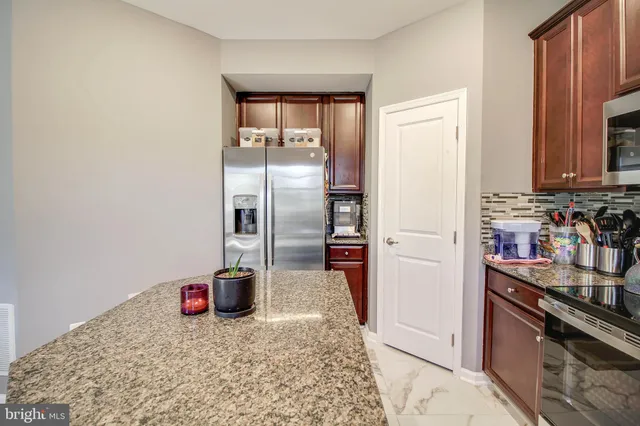 a kitchen with refrigerator and cabinets