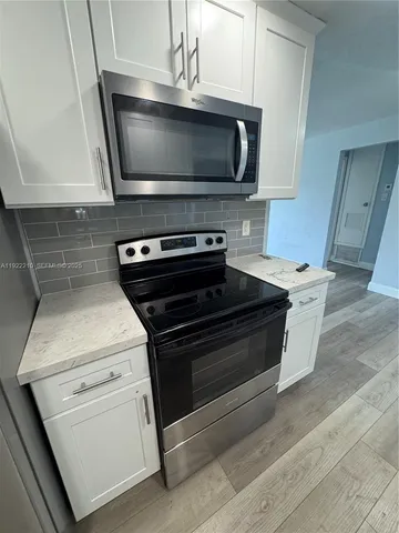 a kitchen with a stove and a microwave