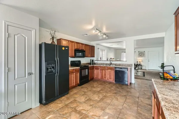 a open kitchen with cabinets and window