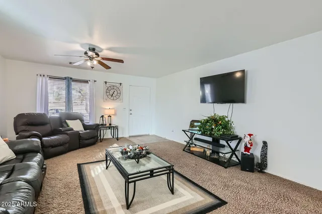 a living room with furniture and flowers