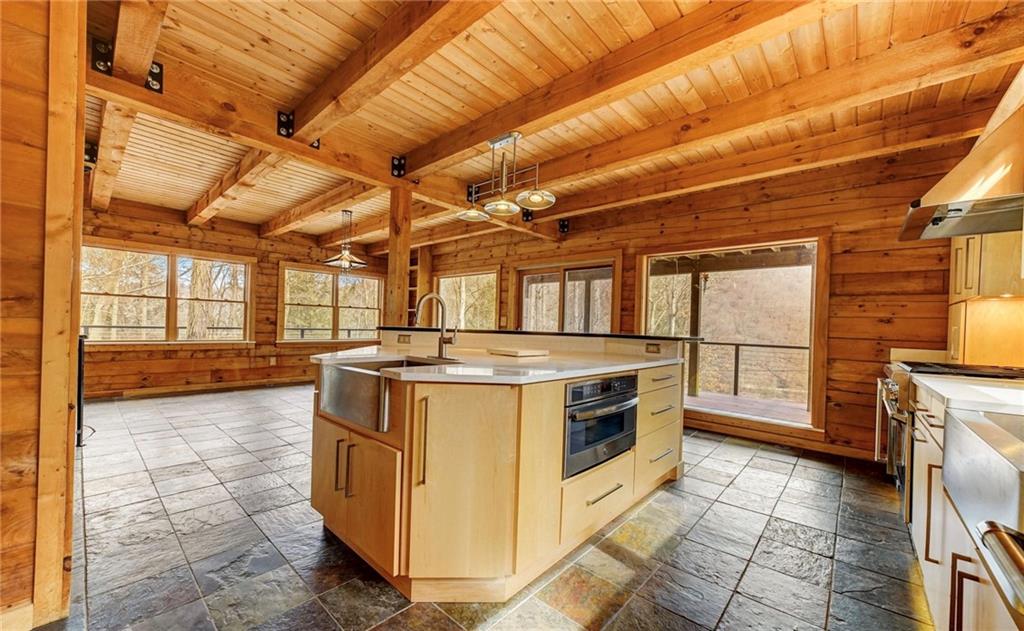 245 Silver Rock Road Adrian, PA 16210 - Photo 18 of 50 a view of a kitchen with wooden floor and electric appliances