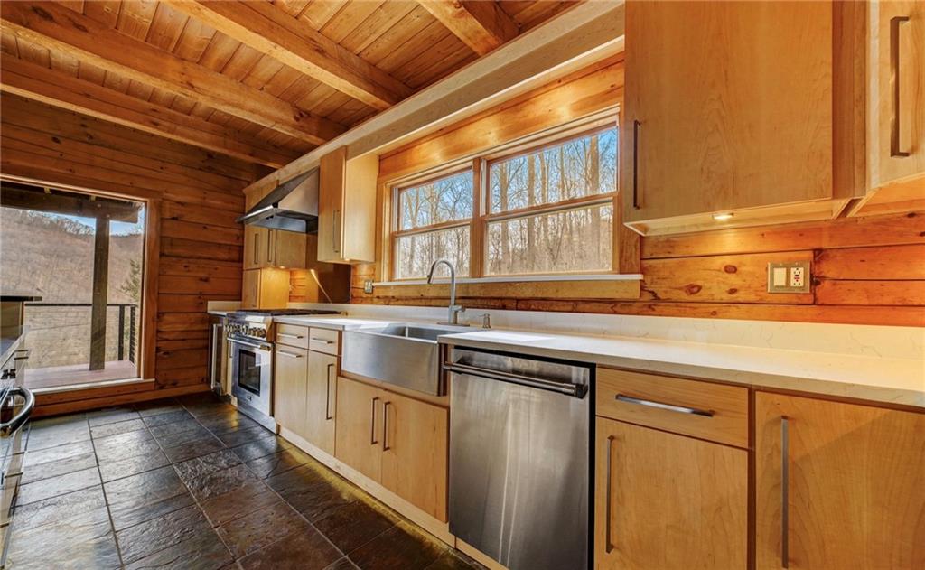 245 Silver Rock Road Adrian, PA 16210 - Photo 19 of 50 a kitchen with stainless steel appliances granite countertop a sink a stove and cabinets