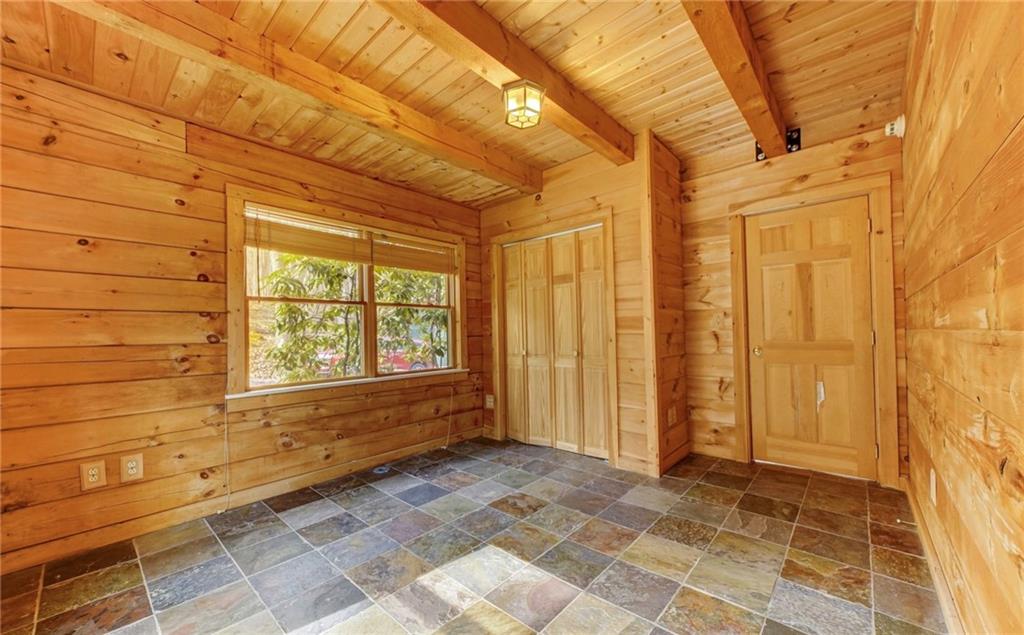 245 Silver Rock Road Adrian, PA 16210 - Photo 20 of 50 a view of a entryway door with a wooden floor and a chair