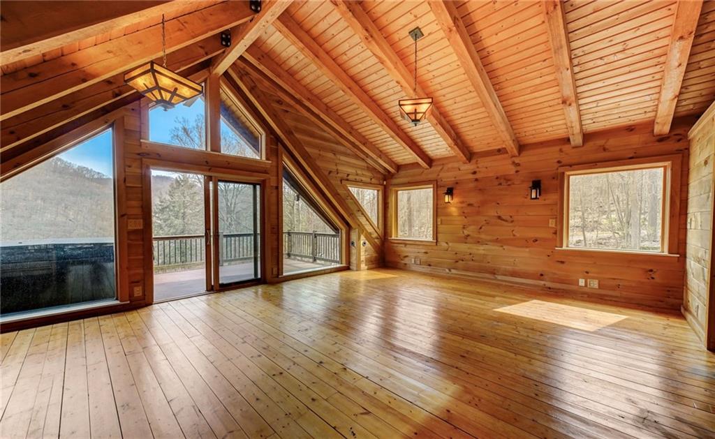 245 Silver Rock Road Adrian, PA 16210 - Photo 23 of 50 a view of an empty room with wooden floor and a window