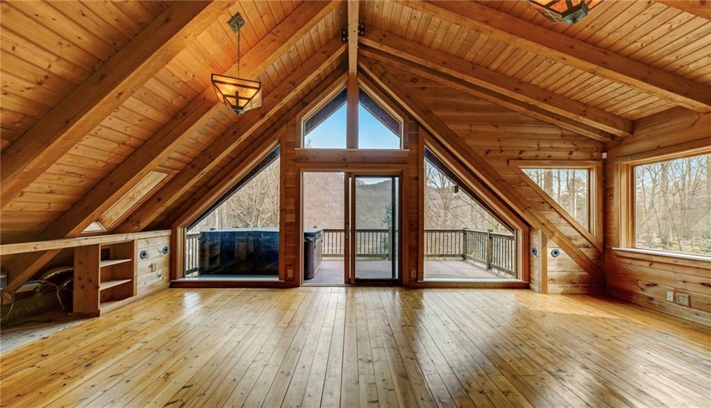 245 Silver Rock Road Adrian, PA 16210 - Photo 24 of 50 a view of an empty room with wooden floor and a ceiling fan