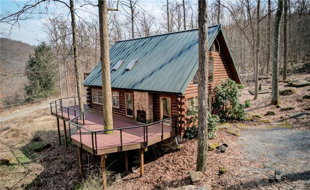 245 Silver Rock Road Adrian, PA 16210 - Photo 43 of 50 a view of wooden house with a yard and sitting area