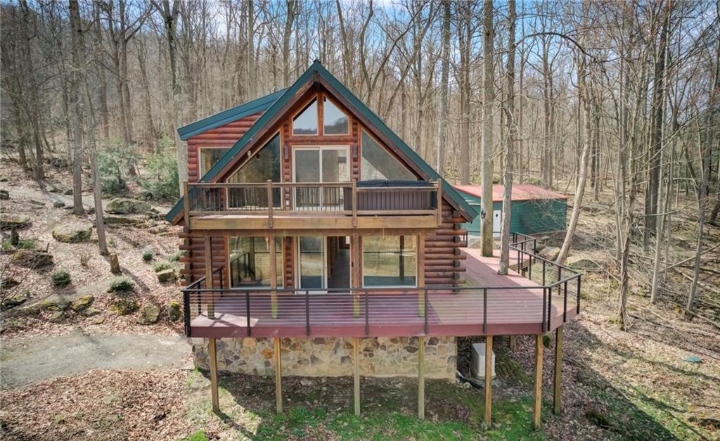 245 Silver Rock Road Adrian, PA 16210 - Photo 44 of 50 a view of a chair and table in the backyard of the house