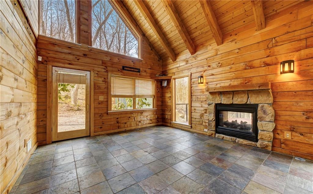 245 Silver Rock Road Adrian, PA 16210 - Photo 8 of 50 a view of an empty room with a fireplace and a window