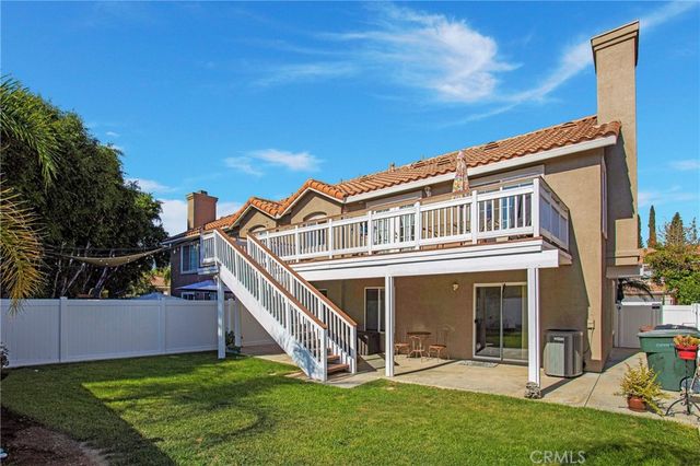 a view of a balcony with wooden floor and iron fence