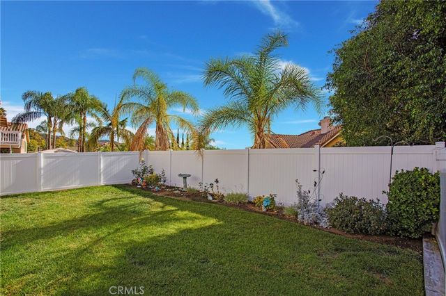a view of a house with a yard and deck