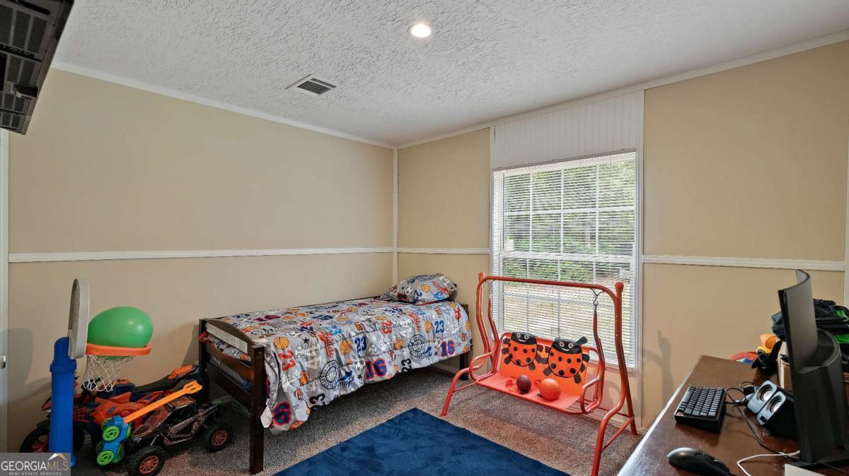 64 Sierra Road Jesup, GA 31545 - Photo 11 of 22 a bedroom with bed and a window