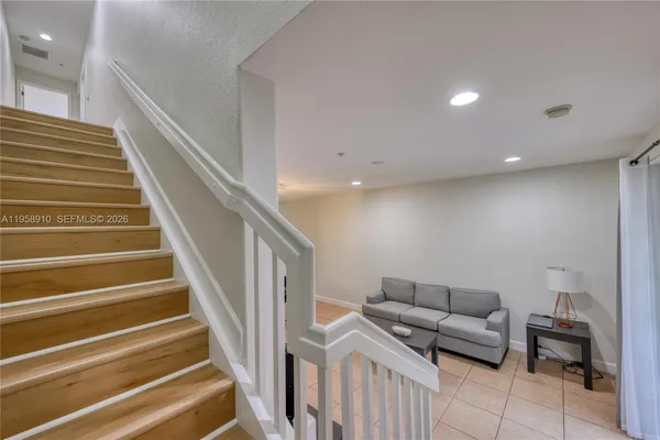 a living room with furniture and a stairs