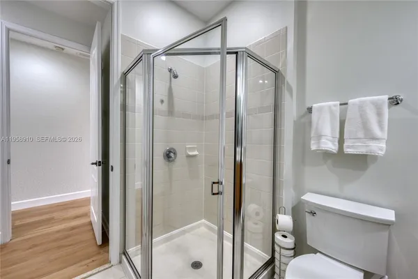 a bathroom that has a glass shower door