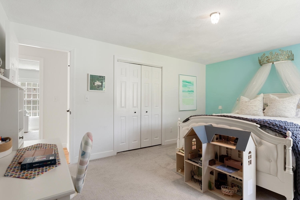 19 Edmonds Road Concord, MA 01742 - Photo 15 of 24 a bedroom with a bed and a chair