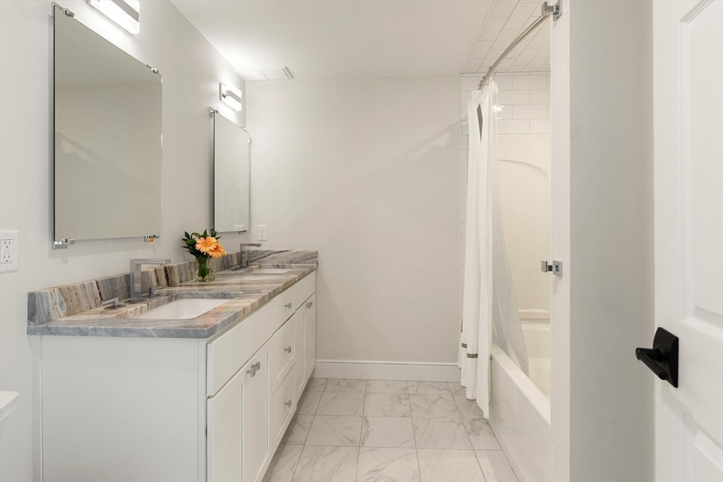 19 Edmonds Road Concord, MA 01742 - Photo 17 of 24 a bathroom with a double vanity sink and a mirror
