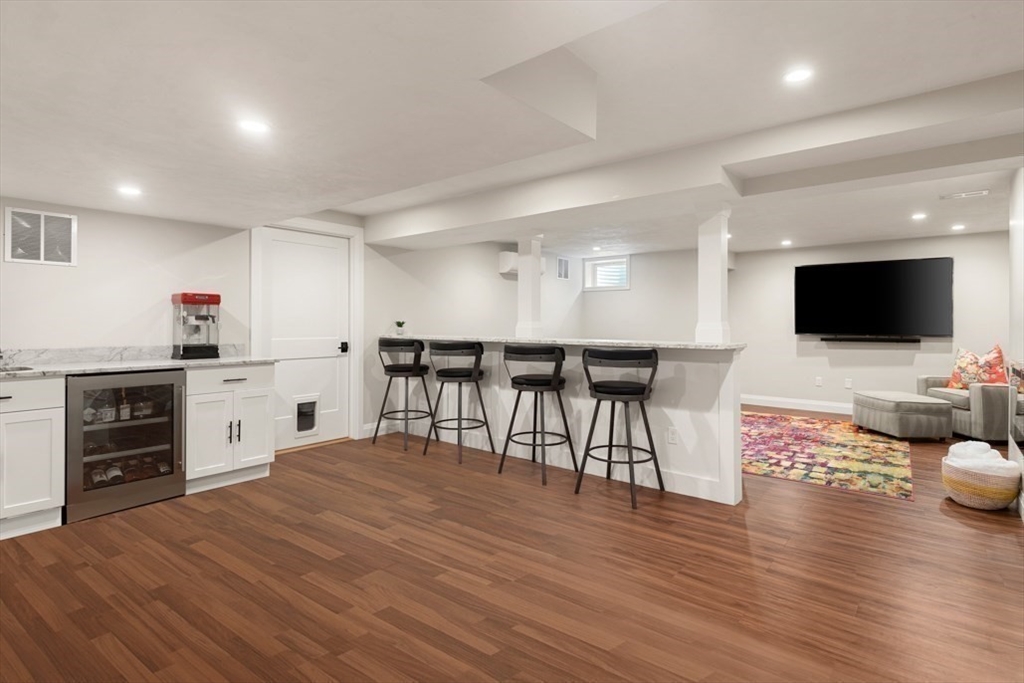 19 Edmonds Road Concord, MA 01742 - Photo 18 of 24 a open kitchen with stainless steel appliances kitchen island granite countertop a stove and a wooden floor