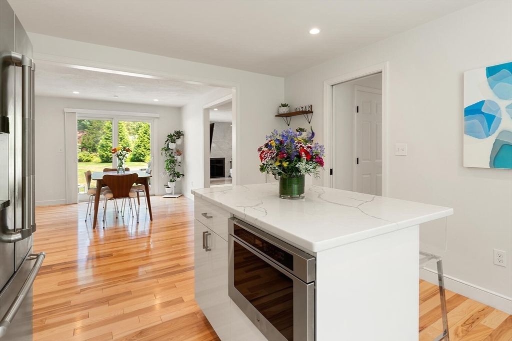 19 Edmonds Road Concord, MA 01742 - Photo 10 of 24 a view of kitchen island with furniture and wooden floor