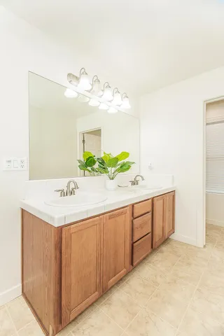a large bathroom with a bathtub and a sink