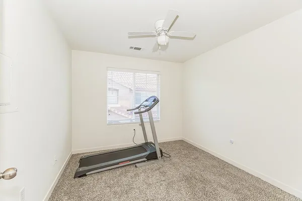 a view of a patio with a table and chairs under an umbrella