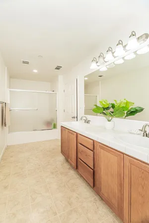 a large bathroom with a bathtub and a sink