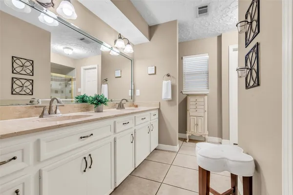 a bathroom with a double vanity sink and a mirror