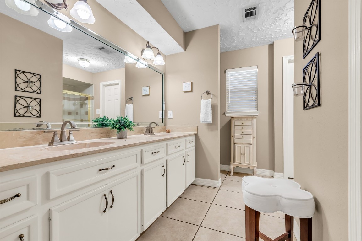 24102 Northcrest Drive Spring, TX 77389 - Photo 14 of 30 a spacious en suite bathroom with a double vanity sink and a mirror