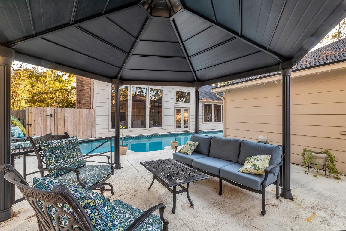 24102 Northcrest Drive Spring, TX 77389 - Photo 28 of 30 a outdoor living space with furniture and umbrella