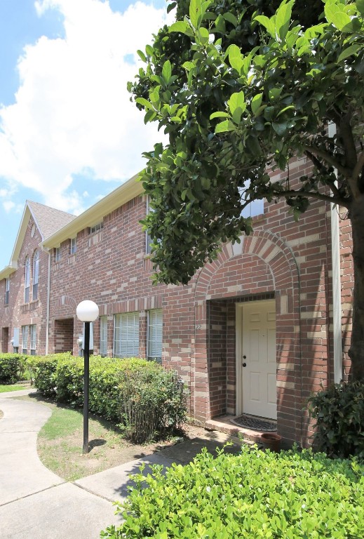 11735 Alief Clodine Road, Unit 22 Houston, TX 77072 - Photo 1 of 23 a front view of a house with a garden and plants