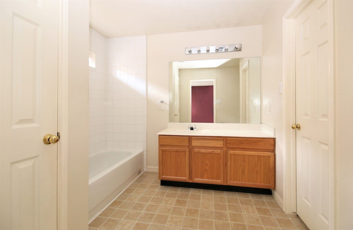 11735 Alief Clodine Road, Unit 22 Houston, TX 77072 - Photo 13 of 23 a spacious bathroom with a tub sink and mirror