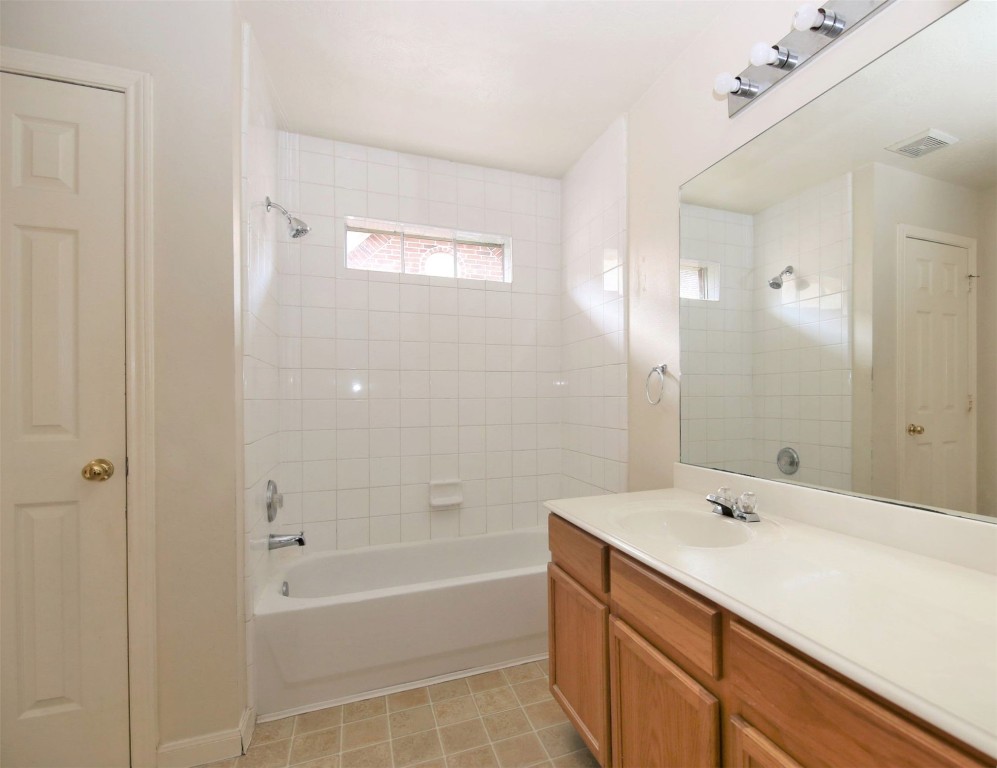 11735 Alief Clodine Road, Unit 22 Houston, TX 77072 - Photo 14 of 23 a bathroom with a tub a sink and mirror