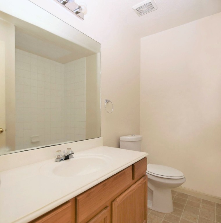 11735 Alief Clodine Road, Unit 22 Houston, TX 77072 - Photo 18 of 23 a bathroom with a sink a toilet and a mirror