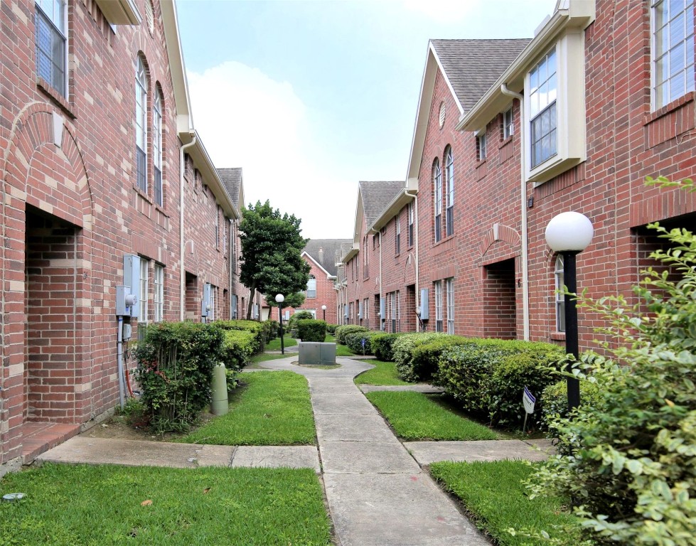 11735 Alief Clodine Road, Unit 22 Houston, TX 77072 - Photo 23 of 23 a view of a brick building next to a yard