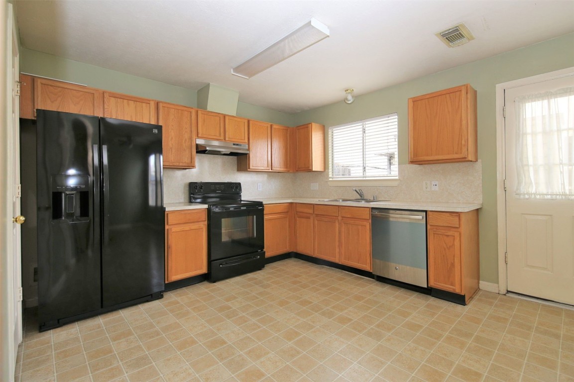 11735 Alief Clodine Road, Unit 22 Houston, TX 77072 - Photo 8 of 23 a kitchen with stainless steel appliances granite countertop a refrigerator and a sink