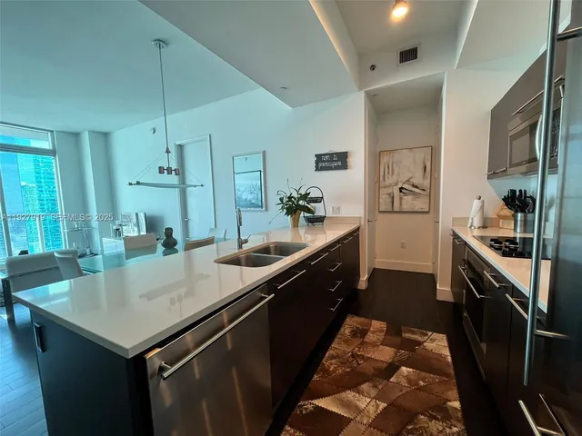 a kitchen with a stove a sink and a refrigerator
