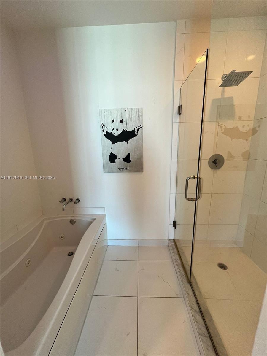 55 Southeast 6th Street, Unit 4103 Miami, FL 33131 - Photo 12 of 24 a bathroom with a bathtub and shower