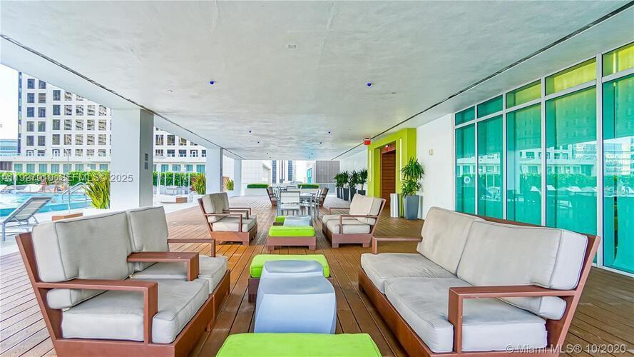 55 Southeast 6th Street, Unit 4103 Miami, FL 33131 - Photo 22 of 24 a living room with furniture and a large window