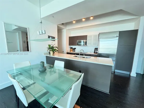a kitchen with a sink cabinets and wooden floor