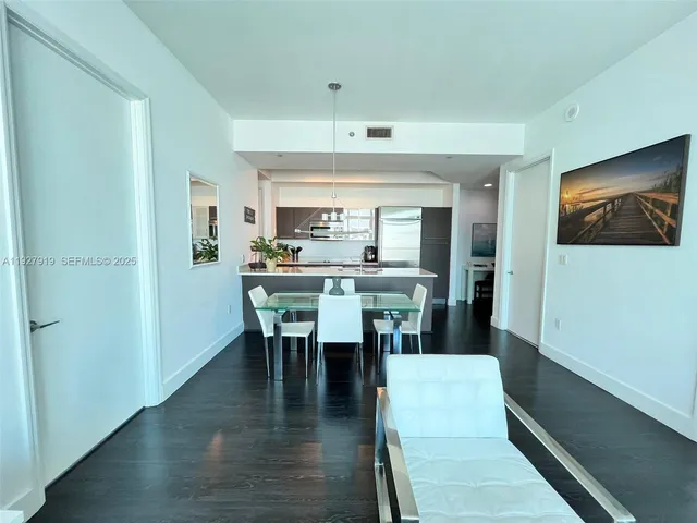 a dining room with furniture window and wooden floor