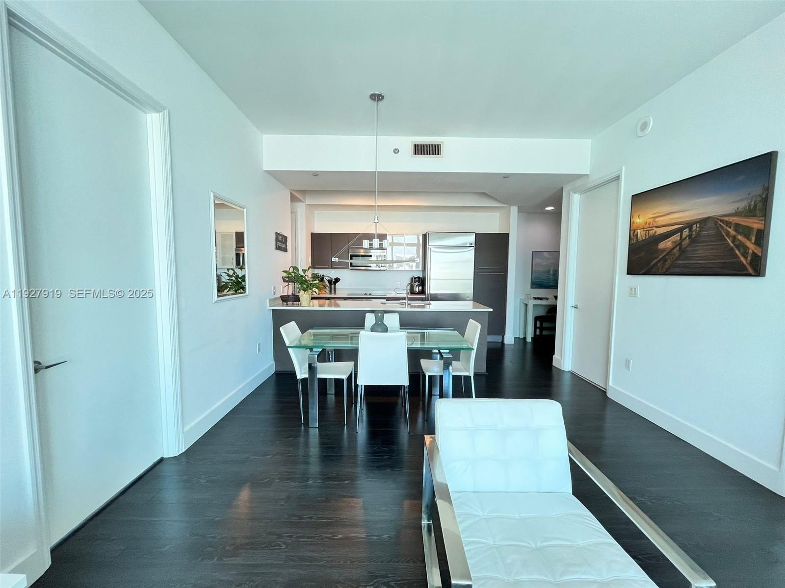 55 Southeast 6th Street, Unit 4103 Miami, FL 33131 - Photo 6 of 24 a dining room with furniture window and wooden floor