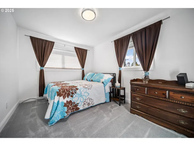 a bedroom with a bed closet and window
