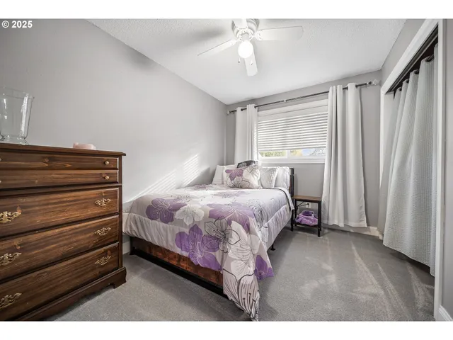 a spacious bedroom with a bed and a dresser