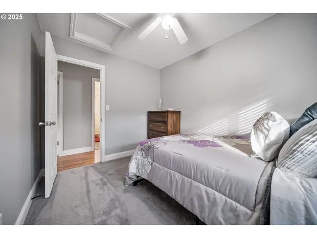 a bedroom with a bed and a ceiling fan