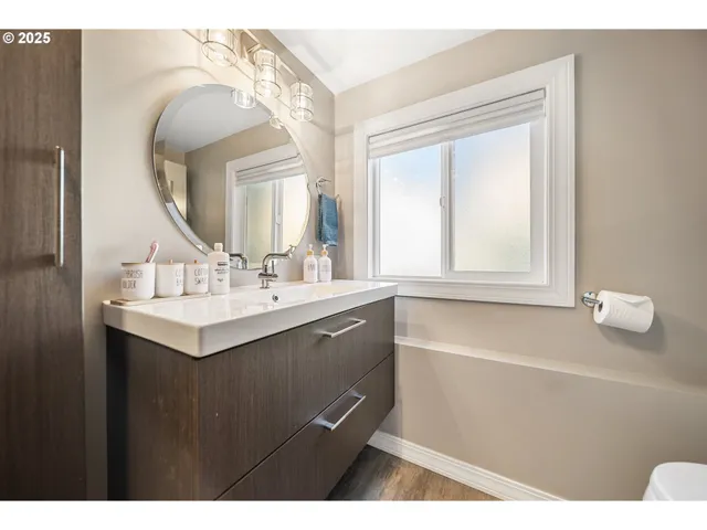 a bathroom with a sink vanity and a mirror