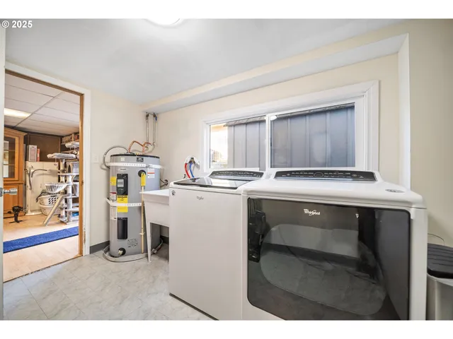 a utility room with cabinets washer and dryer
