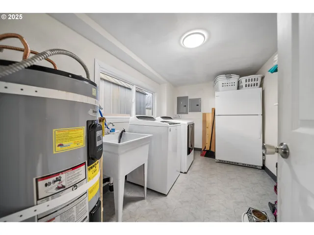 a utility room with cabinets dryer and washer